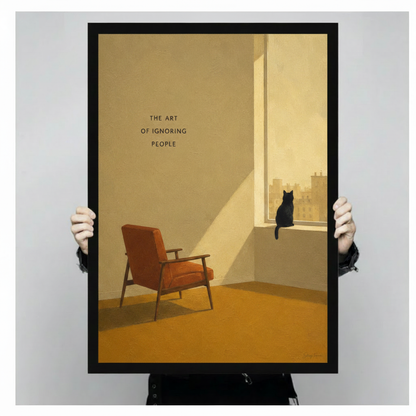 Person holding a large black framed minimalist black cat canvas art print showing a cat silhouette on a golden-lit windowsill with city view and the art of ignoring people quote against a light gray studio background