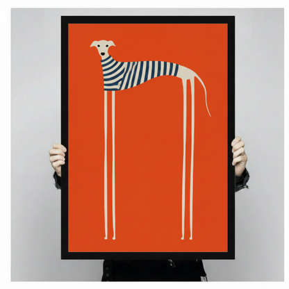 Hand-held display of a framed canvas art print showing a minimalist long-legged greyhound in a navy striped sweater against a bold orange background — modern dog wall art