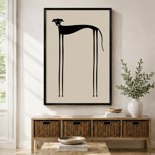 Framed minimalist wall art print of a whimsical black greyhound silhouette with exaggerated long thin legs on a warm beige background, displayed above a wicker storage console in a bright Scandinavian entryway