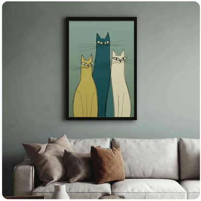 Framed mid-century modern art print of three elongated cats in teal, yellow, and white with expressive eyes, styled above a neutral linen sofa on a sage green wall