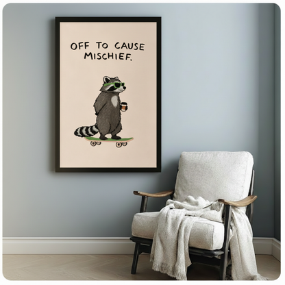 Black framed raccoon mischief poster print hung on a blue-grey wall above a linen armchair, funny animal art for living room or bedroom decor