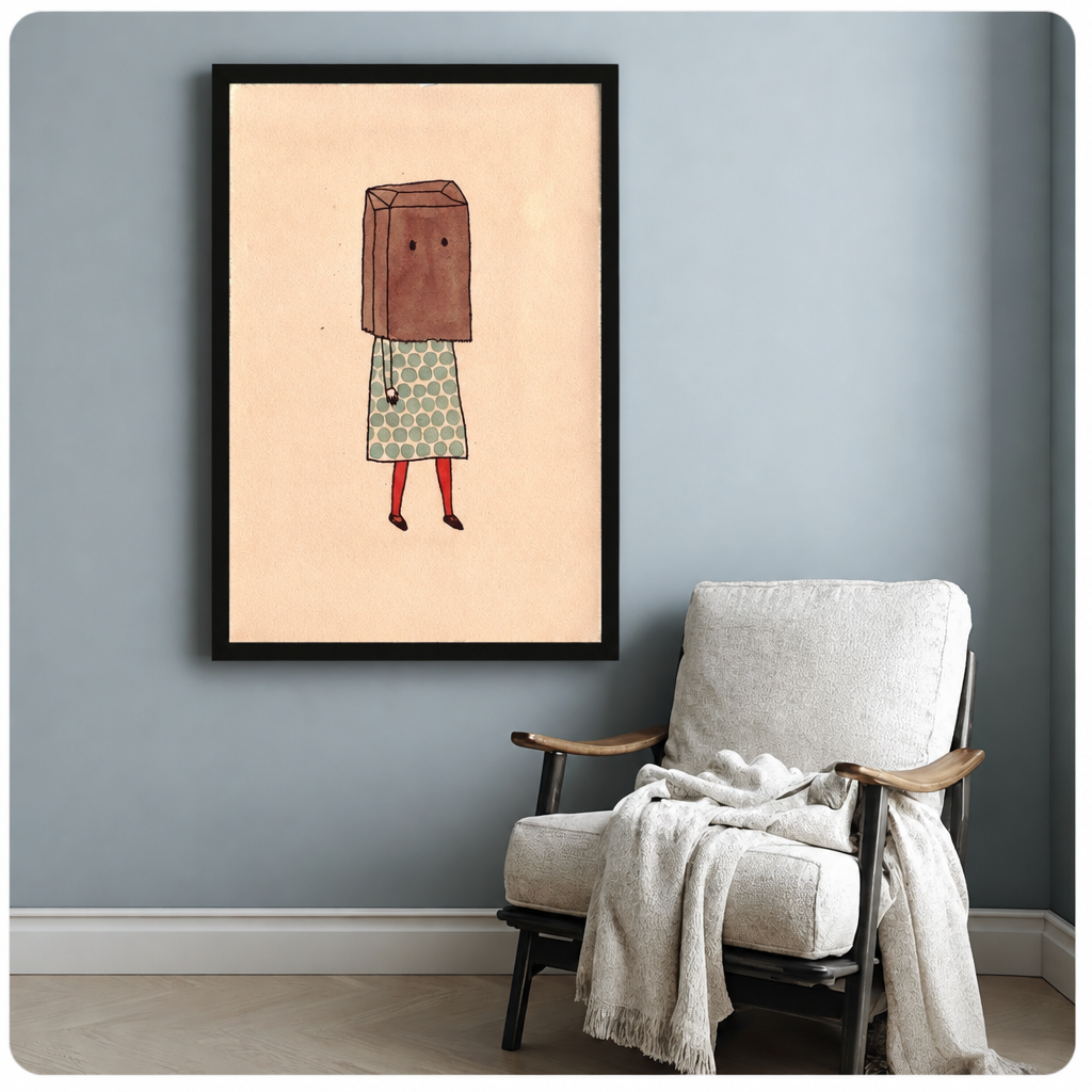Framed paper bag girl wall art beside a cozy armchair on a soft blue-gray wall.