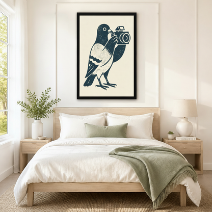 Framed navy blue linocut-style pigeon holding a vintage camera on cream background hung above a light wood bed with white linen in a serene neutral bedroom