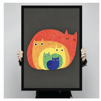 Large black framed canvas of five whimsical nested cats in vibrant rainbow colors on a dark grey background, displayed above a wooden bed as a bold bedroom wall art statement piece