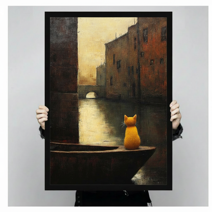 Hand-held display of a black-framed canvas art print featuring an oil painting of a golden orange cat sitting alone on a dark wooden boat in a moody Venice canal — dark academia cat wall art