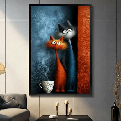 Framed canvas wall art of a whimsical orange and grey cat couple standing beside a steaming coffee cup on a blue-grey textured background with an orange stripe, displayed on a grey tile wall in a modern living room