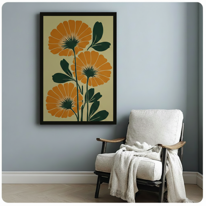 Black-framed botanical art print of large orange marigold flowers with dark green leaves on a warm cream background, styled beside a white armchair in a cozy light-toned reading nook