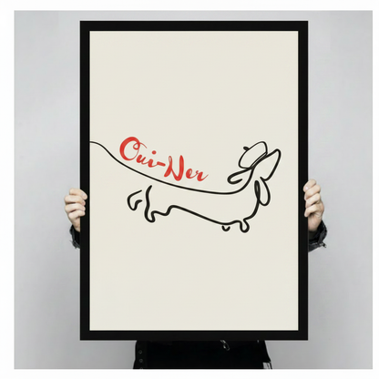 Framed canvas art print of dachshund one-line drawing with red Oui-Ner lettering, held up showing full artwork detail and black frame