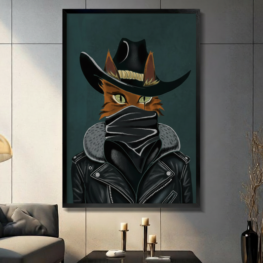 Graphic illustration of an orange cat with sharp green eyes wearing a black cowboy hat black face mask and leather jacket with gray fur collar against a deep teal background outlaw cat wall art framed print in a living room with dark gray panel wall dark sofa and black vase