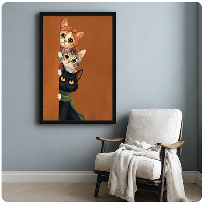 Three cats peeking around a corner orange with bow tabby and black with green scarf funny cat wall art framed print beside armchair blue-gray wall