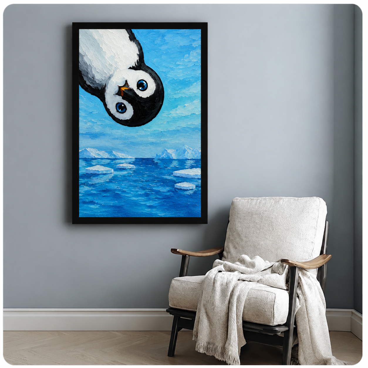 Framed baby penguin oil painting wall art on light gray wall beside white accent armchair, cute Antarctic animal canvas print