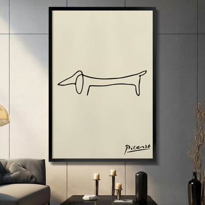 Picasso minimalist dachshund line art black float frame canvas on cream background displayed on dark gray paneled wall above a modern console table with brass candlestick holders and black ceramic vase