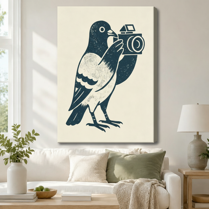 Gallery-wrapped canvas of a bold navy linocut pigeon clutching a retro camera on cream background hung above a white sofa in a cozy Scandinavian living room
