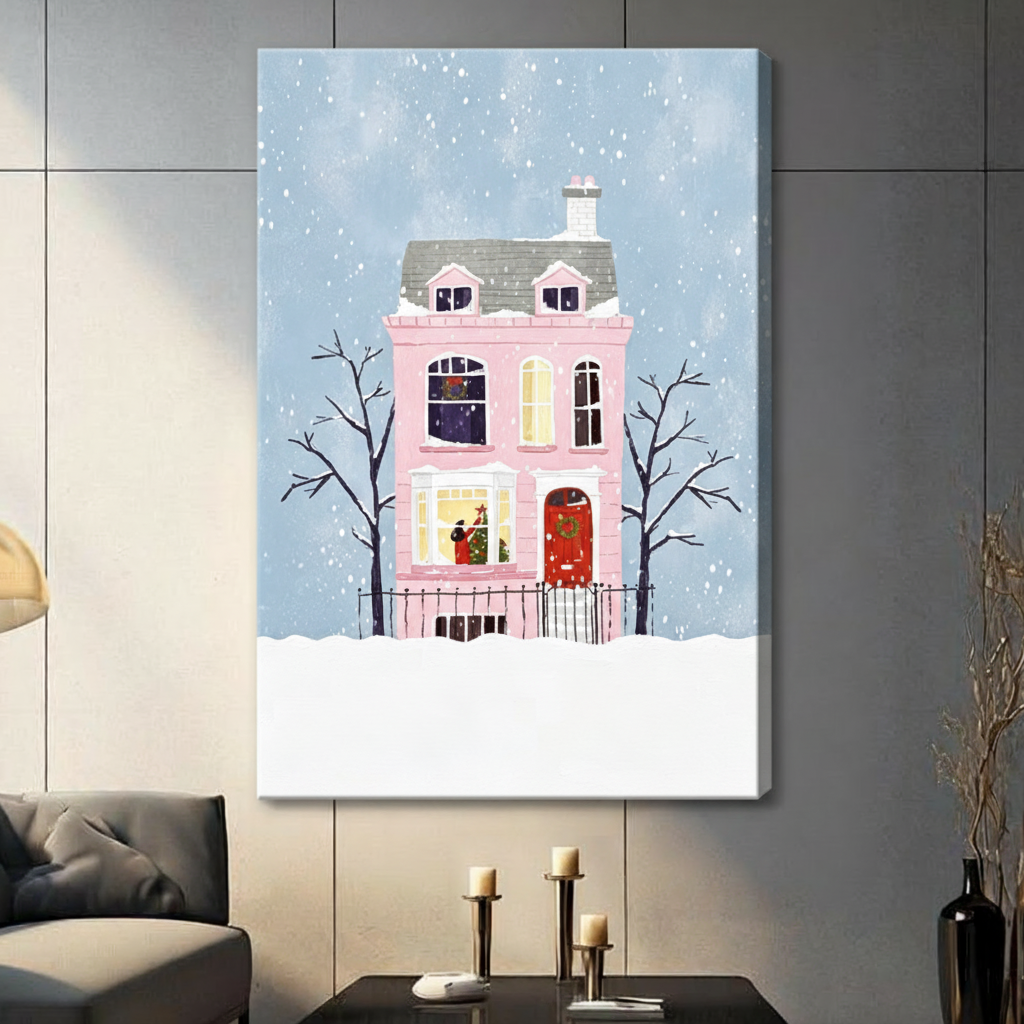 Whimsical flat illustration of a pink Victorian house with a red door and wreath surrounded by bare trees in falling snow Christmas wall art stretched canvas in living room with light gray panel wall and dark sofa