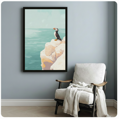 Framed puffin sea cliff wall art beside wooden accent chair with throw blanket - serene coastal bird canvas print for reading nook or study