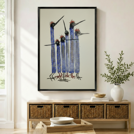 Quirky blue long-necked birds flock framed wall art print hung above wicker storage console in boho entryway