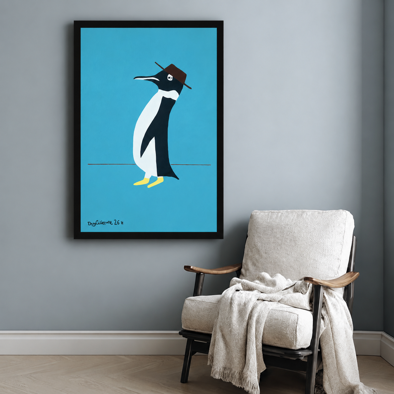 Quirky penguin in brown hat framed poster beside accent chair on blue-grey wall, retro minimalist animal art print for eclectic home decor