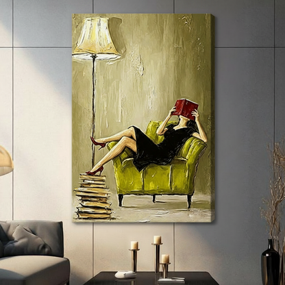 Stretched canvas artwork features a woman reading in a green chair with visible side depth and realistic wall shadow.