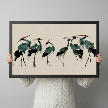 Person holding red-crowned crane framed wall art print, showing size and scale of artwork