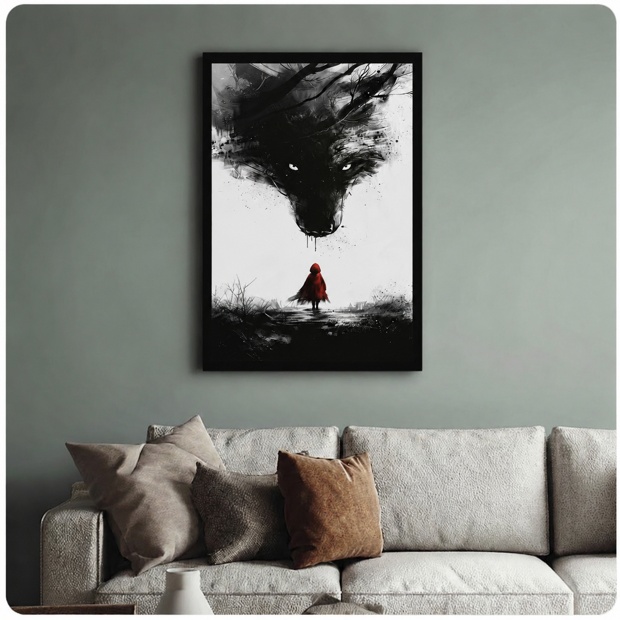 Black-framed gothic fairy tale wall art featuring a red-cloaked girl confronting a looming wolf, hung above a neutral sofa on a sage green wall