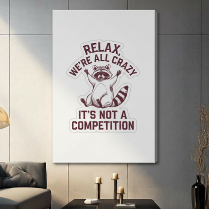 Canvas wrap wall art with humorous raccoon graphic and bold typography reading Relax We're All Crazy It's Not A Competition, hung on a gray wall in a contemporary living room