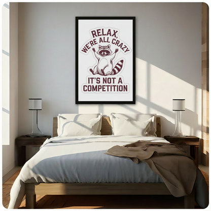 Framed raccoon funny quote wall art reading Relax We're All Crazy It's Not A Competition, hung above a bed in a cozy neutral-toned bedroom with natural light