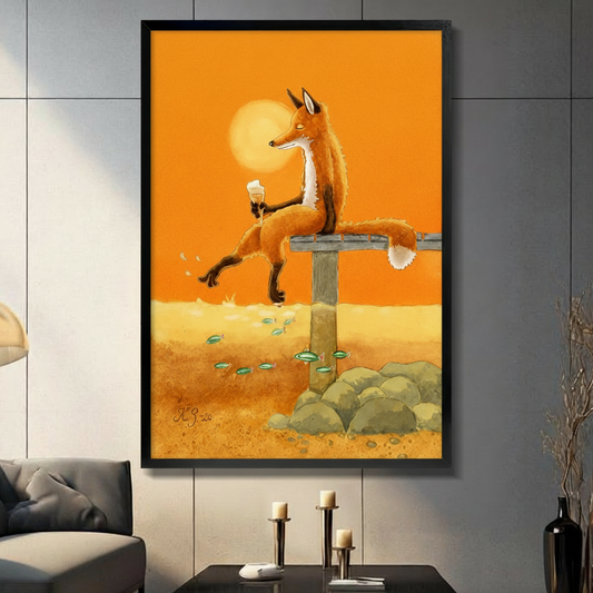 Framed wall art of a relaxed fox sitting on a bench holding a wine glass at golden sunset displayed in modern dark living room