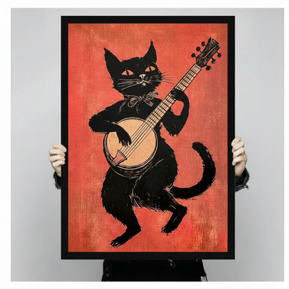 Retro black cat banjo folk art print held up showing full linocut illustration on orange-red background, vintage music wall art in black frame against neutral gray background