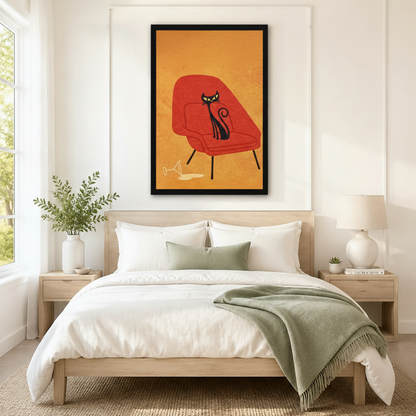 Black framed retro mid-century black cat on a red womb chair canvas art with a sleek yellow-eyed black cat lounging on an orange-red modern armchair with black tapered legs and a tipped martini glass on a warm golden textured background, hung above a wooden bed frame in a sun-drenched bedroom with crisp white linen bedding, a sage green throw, and a round white nightstand lamp