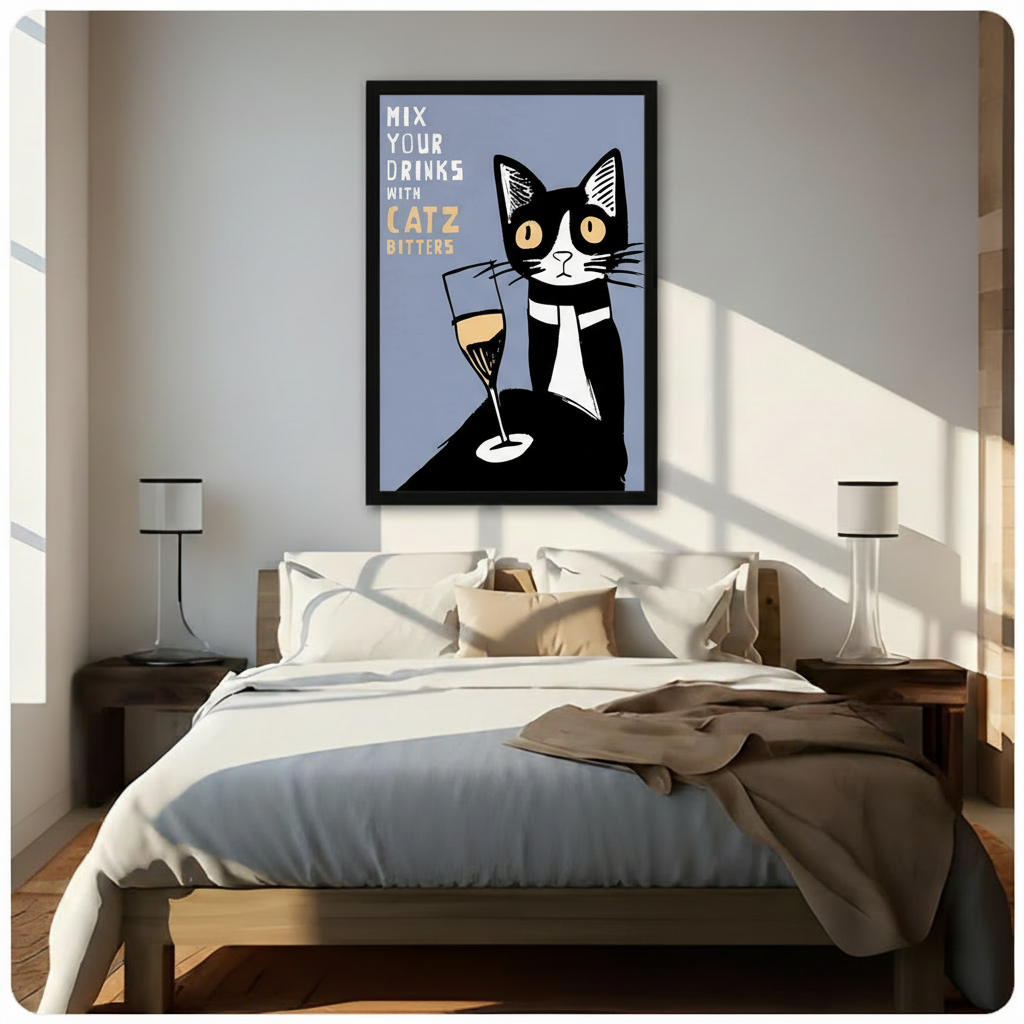 Black framed retro poster style tuxedo cat with champagne glass Mix Your Drinks With Catz Bitters canvas art with a bold black and white tuxedo cat with wide amber eyes seated beside a tall champagne flute with golden liquid on a muted slate blue background with white and gold hand-lettered text, hung above a dark wood bed with white linen bedding in a sunlit bedroom