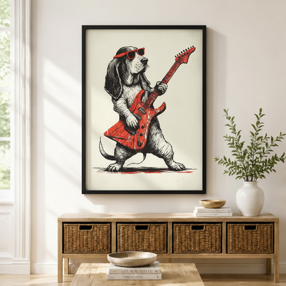 Black framed whimsical rock dog Basset Hound electric guitar sketch print mounted above a wicker basket storage console with white ceramic vases, stacked coffee table books, and a wooden bowl in a warm minimal entryway