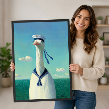 Woman holding a black-framed sailor goose art print showing scale and print quality in a lifestyle setting