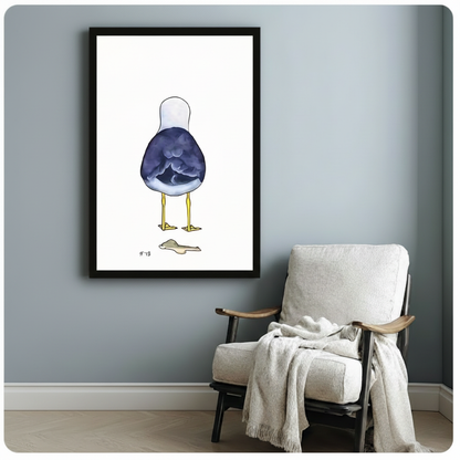 Black framed minimalist seagull back view coastal humor canvas print with blue-purple watercolor bird on white background hung on a soft blue-gray wall beside a white linen wood armchair with cream knit throw