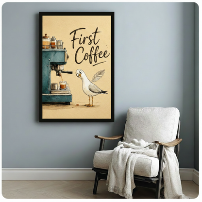 Black framed funny coastal bird illustration of a surprised white seagull with big round eyes peering at a vintage blue-green espresso machine brewing espresso with glass jars on top and the phrase First Coffee in bold handwritten script whimsical humor canvas print on warm cream background hung on a soft blue-gray wall beside a white upholstered wood armchair with cream throw
