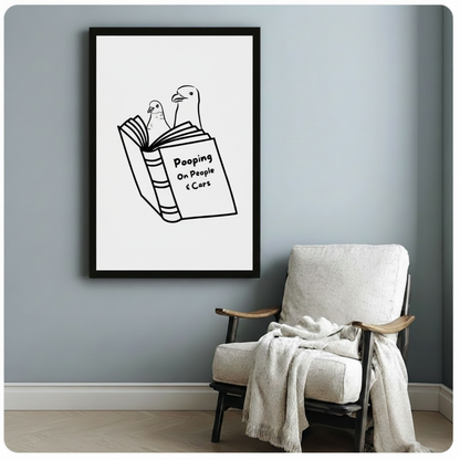 Witty seagull reading book framed poster beside cozy armchair, funny bird humor wall art in black frame on blue-gray wall, minimalist line art for living room or office