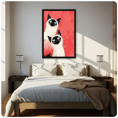 Framed modern expressionist oil painting two Siamese cats with teal blue eyes and black facial markings gazing forward on vivid red textured background canvas print above wooden bed in sunlit minimalist bedroom - bold Siamese cat duo wall art with brushstroke coral red background for contemporary bedroom home decor