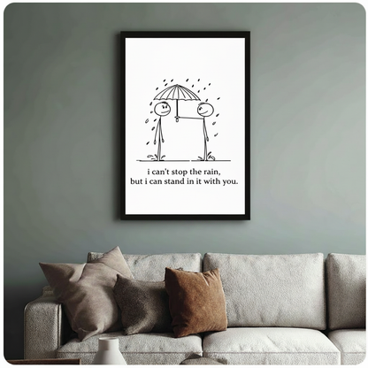Framed stick figure couple sharing umbrella love quote canvas print above cream sofa on sage green wall - minimalist black and white i can stand in it with you romantic wall art for stylish living room decor