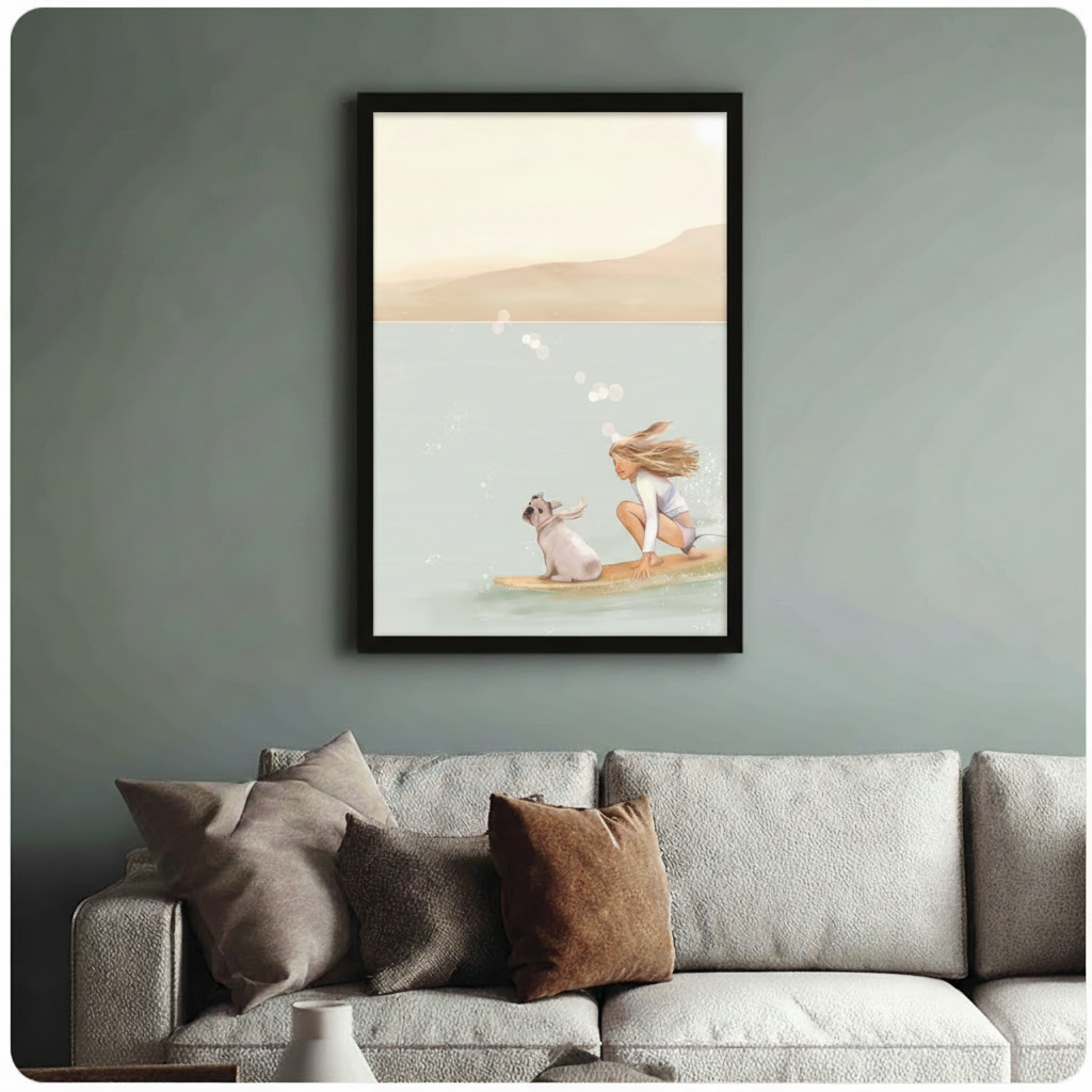 	Black-framed poster of a girl and her French bulldog surfing together on a warm beige and teal watercolor background, hung above a linen sofa