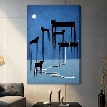 Stretched canvas wall art featuring five surreal elongated black cats with melting dripping legs under a luminous full moon and scattered stars on a moody cobalt blue background, with a sinuous white snake winding across the ground, hung on a gray tile wall beside a modern charcoal sofa
