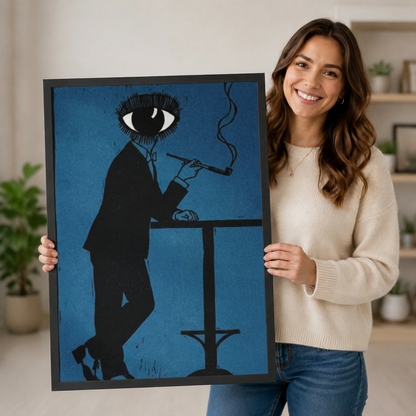 Smiling woman holding a black framed surrealist eye-head figure smoking pipe art print in deep blue against a neutral indoor background with potted plants
