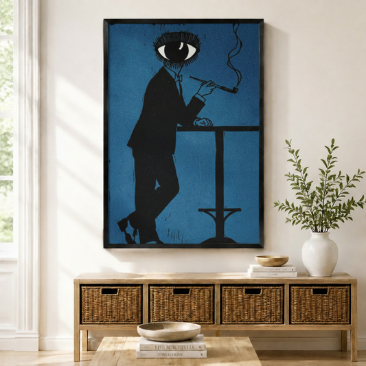 Black framed surrealist eye-head man smoking pipe wall art in cobalt blue hanging above a rattan sideboard with wicker baskets in a bright Scandinavian living room