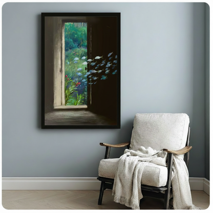 Black framed surrealist art print of mysterious open door with lush garden beyond and silver fish school, styled on blue-gray wall beside white linen armchair