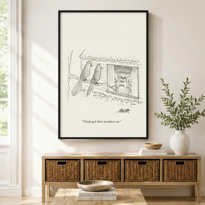 Funny New Yorker style bird and indoor cat cartoon art print in black frame above wicker console table in bright neutral entryway