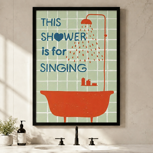 Framed bathroom wall art print featuring retro orange clawfoot bathtub with shower and bold blue text reading This Shower Is For Singing on mint green tile background