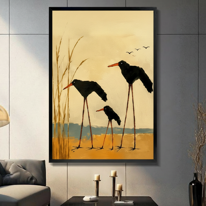 Framed canvas wall art of three black oystercatcher birds with orange beaks standing in golden wetland reeds, oil painting style, displayed in dark modern living room with candlesticks
