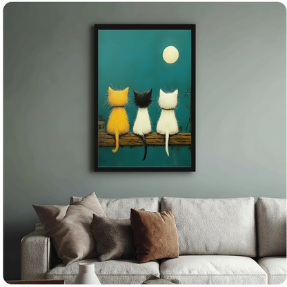 Black framed wall art of three cats on a fence at night, styled above a beige sofa in a cozy living space