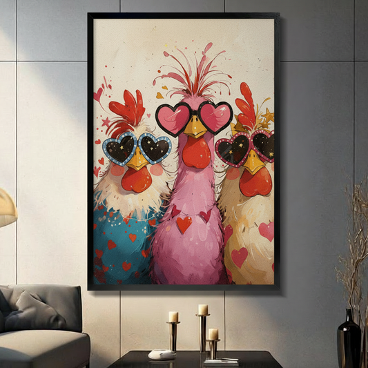Framed colorful wall art print of three funny chickens wearing heart-shaped sunglasses with red hearts and confetti, displayed above a white linen bed in a bright minimalist bedroom