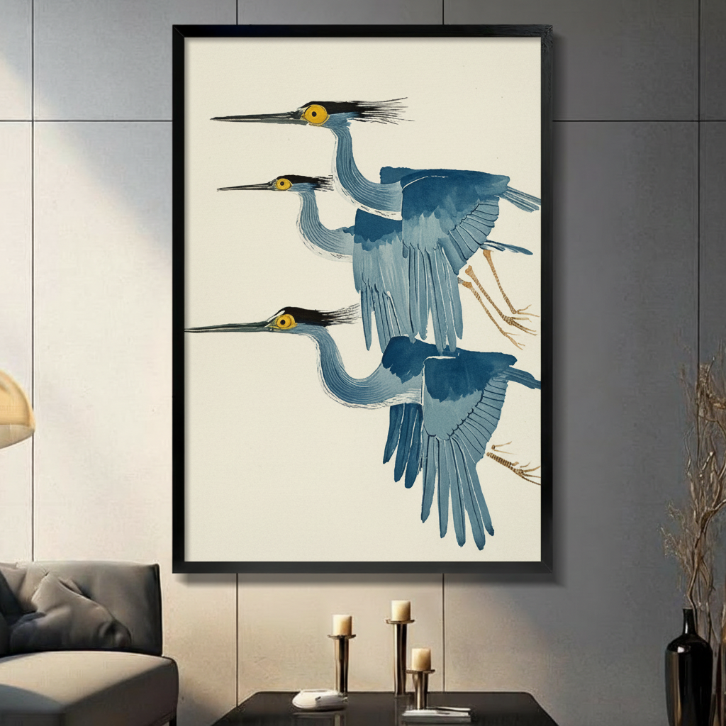 Three flying herons in Japanese ukiyo-e watercolor style framed wall art - elegant blue grey heron canvas print with golden yellow eyes black crests and warm cream background for living room decor