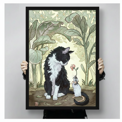 Enchanting illustration of a fluffy black and white cat bending toward a small white mouse offering a pink flower with detailed botanical leaf background and warm cream light framed wall art print held up for size reference against a light gray neutral backgroun
