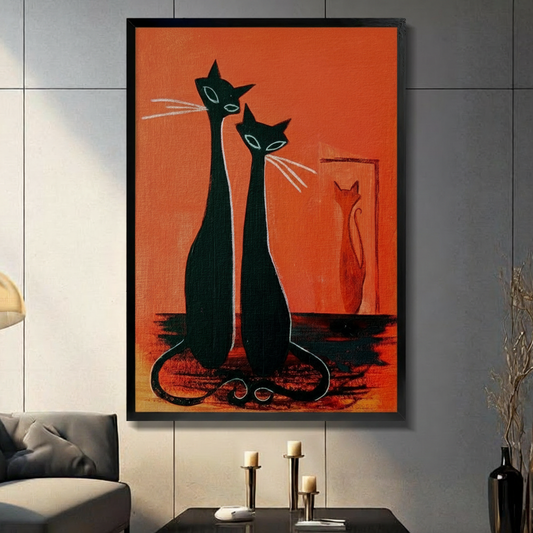 Mid-century modern graphic oil painting of two slender elongated black cats sitting side by side with pointed ears teal almond eyes and white whiskers their tails curled together at the base with a small orange cat silhouette in a framed doorway behind them against a bold orange-red background striking cat wall art framed print in a living room with light gray panel wall dark sofa and black vase